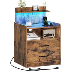 a wooden desk with a blue light on top and an old radio in the bottom drawer