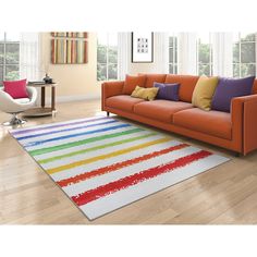 a living room with an orange couch and colorful rug