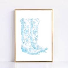 a blue and white drawing of a pair of cowboy boots with flowers on the inside