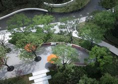 an aerial view of a park with benches, trees and walkways in the center