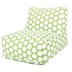 a green and white polka dot print chair with pillows on the bottom half of it