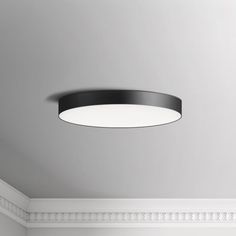 a modern ceiling light in a white room