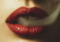 a woman's lips are painted red with white strips on the tip of her lip