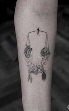 a tattoo on the leg of a person with two hands holding something in front of them