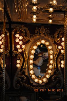 an ornate mirror with lights around it