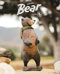 a statue of a bear on its hind legs with the words little bear above it