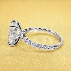 two wedding rings with diamond accents on a yellow background, one is white gold and the other is silver