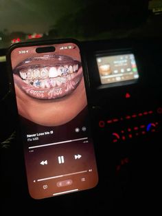 someone is holding up their cell phone to take a picture of the teeth on it