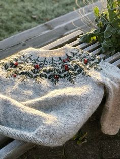 a sweater sitting on top of a wooden bench