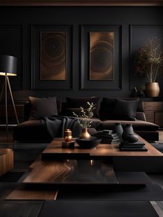 a living room with black furniture and paintings on the wall above it's coffee table