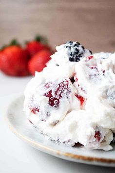 a white plate topped with whipped cream and berries