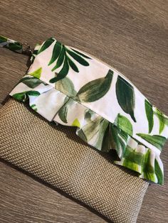 a green and white purse sitting on top of a wooden table