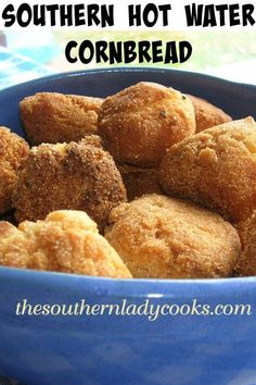 a blue bowl filled with fried cornbreads on top of a table