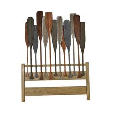 a wooden rack with several different types of paddles on it