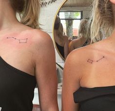 two women with small tattoos on their backs