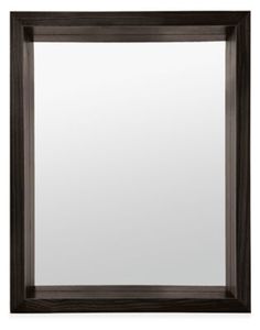 a black framed mirror sitting on top of a white wall next to a wooden frame