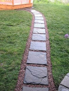 a stone path in the middle of a yard