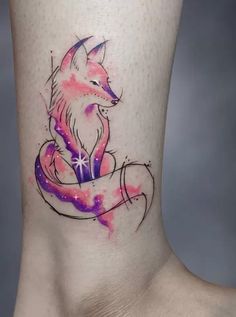 a tattoo on the leg of a woman with a pink and purple fox sitting on top of it