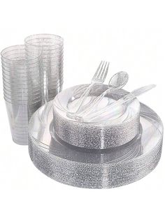 there is a plate with silverware on it next to cups and spoons,