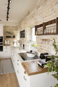 a kitchen with white cabinets and wooden counter tops