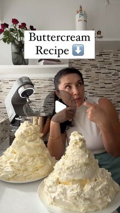 a woman sitting in front of two large cakes on top of a white counter with the words buttercream recipe below her