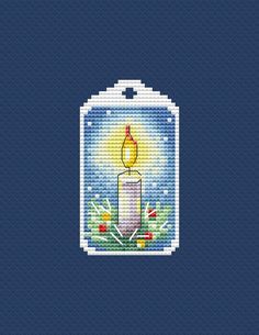 a cross stitch pattern with a lit candle