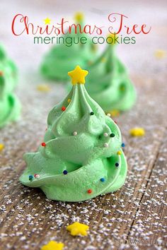 green christmas tree meringue cookies with sprinkles on a wooden table