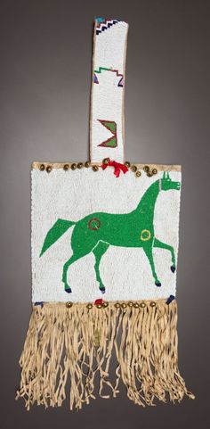 an ornament with a horse on it and fringes hanging from the side