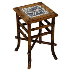 a small wooden table with a tile top