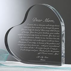 a glass heart shaped award with the words dear mom on it