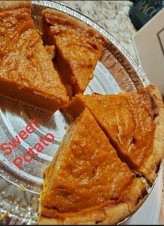 a pie sitting on top of a glass plate next to a box with a slice cut out