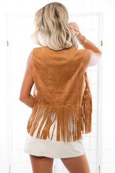 Step into bohemian chic with the Fleetwood Camel Suede Embroidered Fringe Vest! This trendy vest features an open front, sleeveless design, and is crafted from luxurious faux suede for a stylish and comfortable fit. The solid camel color is adorned with intricate ivory floral embroidery on the front, while fringe accents on the hems add a playful touch. With its cropped styling, this vest is the perfect statement piece to elevate any outfit with a touch of free-spirited flair! Features: Luxuriou Bohemian Brown Vest Top, Brown Fringed Tops For Festival, Brown Fringe Tops For Festival, Brown Fringe Top For Festival, Brown Sleeveless Bohemian Top, Brown Fringe Vest For Festival, Festival Fringe Brown Vest, Hippie Style Vest For Fall Festival, Bohemian Embroidered Vest For Summer