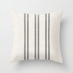 a black and white striped pillow sitting on top of a wall