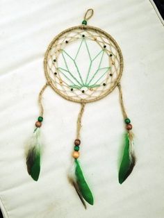 a green and white dream catcher sitting on top of a table