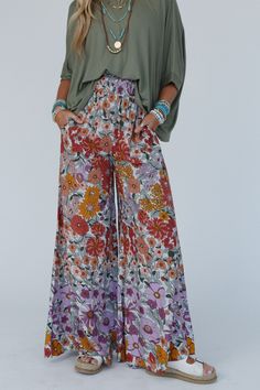 Elevate your boho wardrobe with the Blissful Burst Floral Pants - with their trendy wide legs and comfortable fit, you'll feel stylish and confident in any setting! Boho fabric that drapes beautifully and adds a touch of texture Bold floral print for an eye-catching look Palazzo silhouette with flared wide legs for a relaxed and breezy feel Thick smocked elastic waistband for good fit Convenient side seam pockets Pair with: Sophie Crochet Lace Bralette, On The Go V Neck Ribbed Essential Tee and Blue Floral Pants Outfit, Summer Floral Print Wide Leg Maxi Skirt, Casual Floral Print Maxi Bottoms, Casual Maxi Length Bottoms With Floral Print, Casual Maxi Length Floral Print Bottoms, Flowy Wide-leg Maxi Skirt For Day Out, Spring Floral Print Wide Leg Pants, Hippie Boho Print Vacation Bottoms, Spring Maxi Bottoms For Day Out