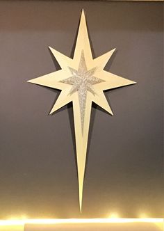 a lighted christmas star hanging from the ceiling