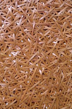 a close up view of woven material with small pieces of wood in the center and bottom