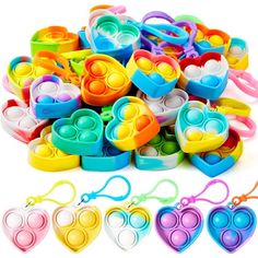 lots of colorful heart shaped plastic toys on a white background with clippings for each item