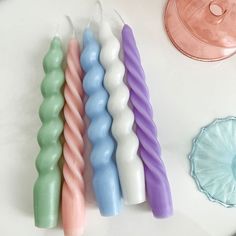 four candles sitting next to each other on a table