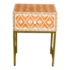 an orange and white patterned table with two drawers on one side, the other end