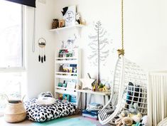 a bedroom with a hammock chair, bookshelf and other items on the floor