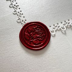 a red wax seal on a white background