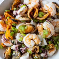 a white bowl filled with shrimp and vegetables