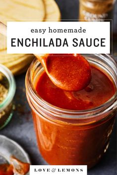 an easy homemade enchilada sauce in a mason jar with a wooden spoon