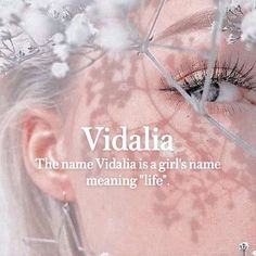 a woman's face with the words vidalia on it and flowers in front of her