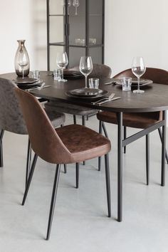 a dining room table with four chairs around it