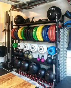 a rack filled with lots of different colored dumbbells