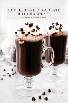 two glasses filled with hot chocolate and whipped cream