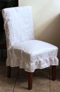 a white chair sitting on top of a tiled floor