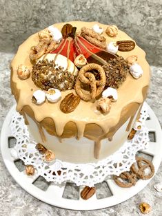 a cake with nuts and pretzels on top